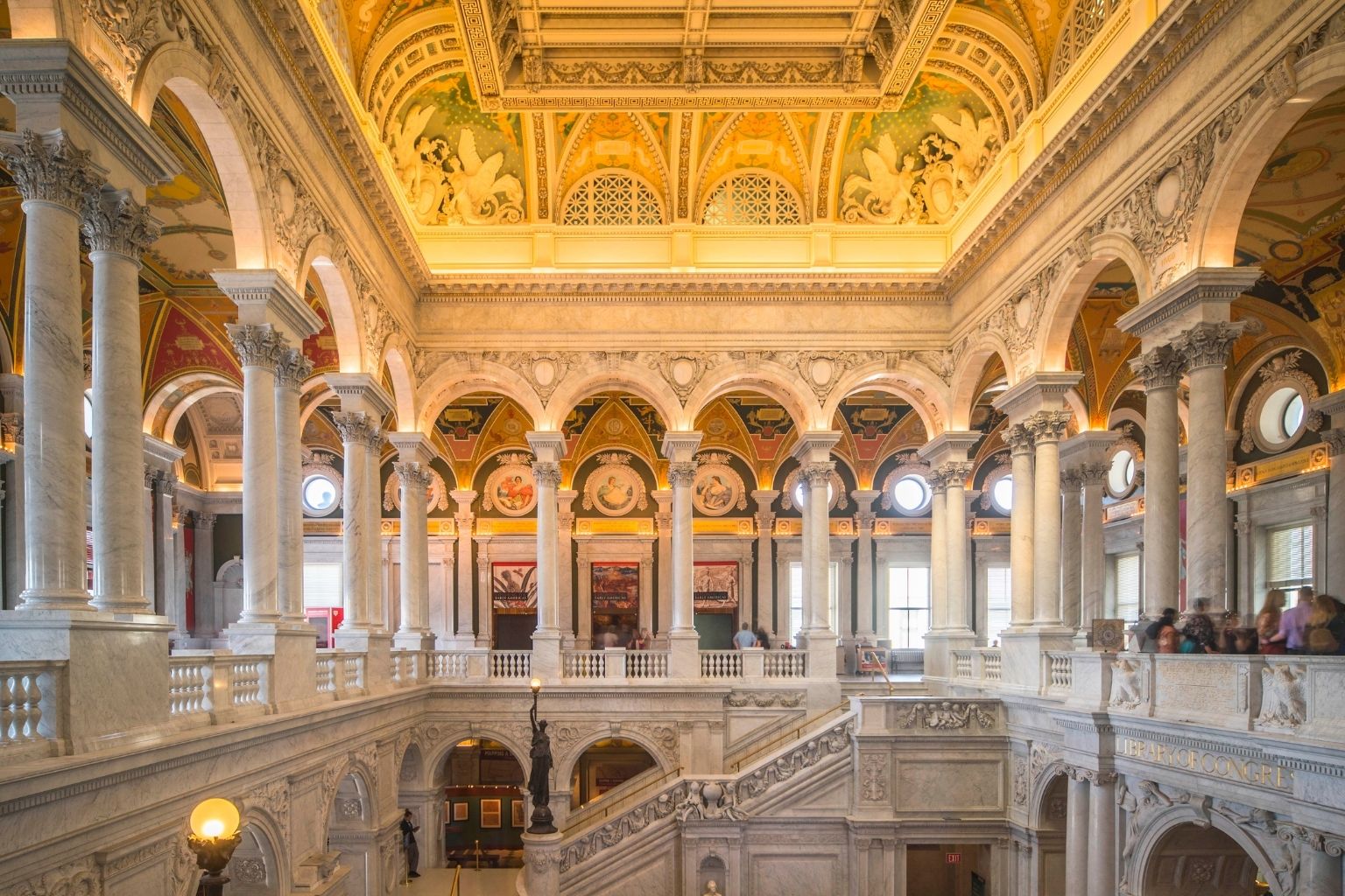 a large ornate building with many columns and a staircase with Library of Congress in the background