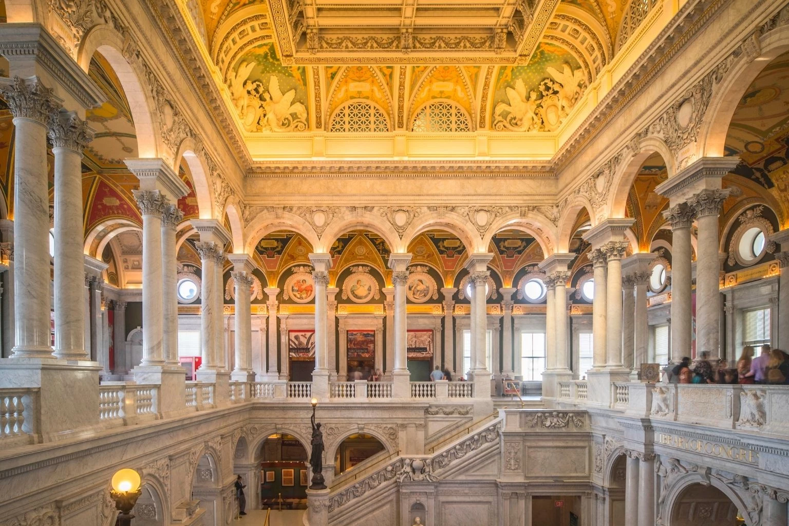 a large ornate building with many columns and a staircase with Library of Congress in the background