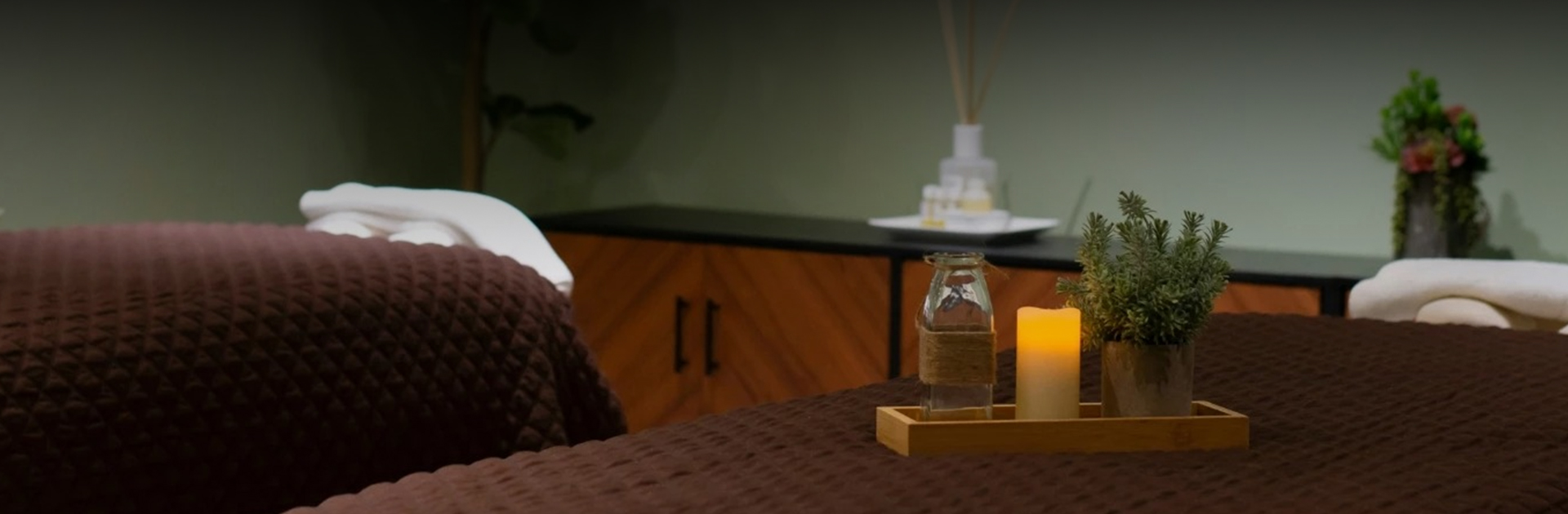 a candle and a bottle on a table