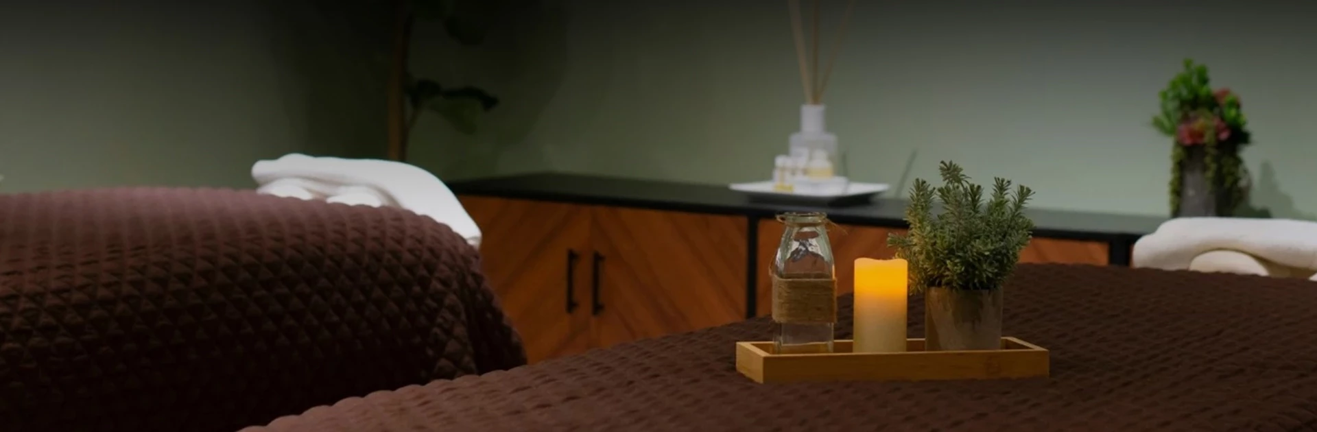 a candle and a bottle on a table