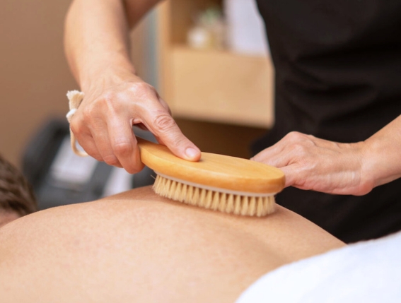 a person brushing the skin of a person's back