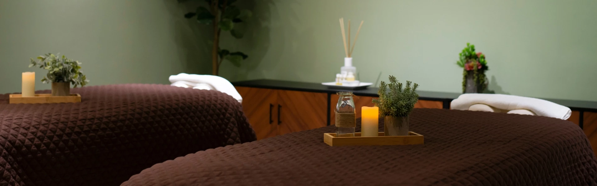 a table with candles and a plant on it