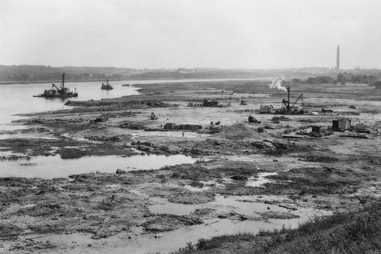 Historic view of the Potomac Flats floodplain in Washington DC circa 1914, showing muddy terrain, early dredging work, and the future site of the Lincoln Memorial before construction began.