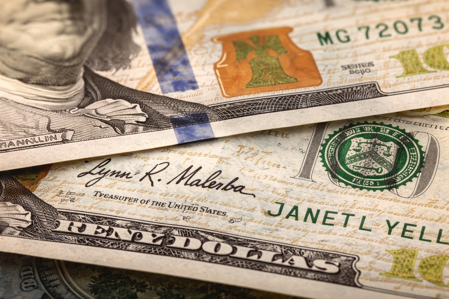 Close-up of U.S. dollar bill showing Treasury signatures and detailed engraving on American currency