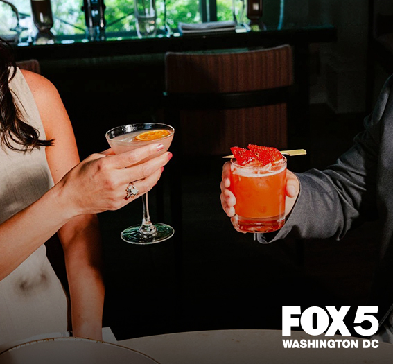 a man and woman holding drinks
