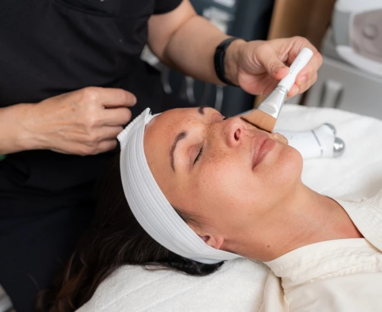 a woman getting a face mask treatment