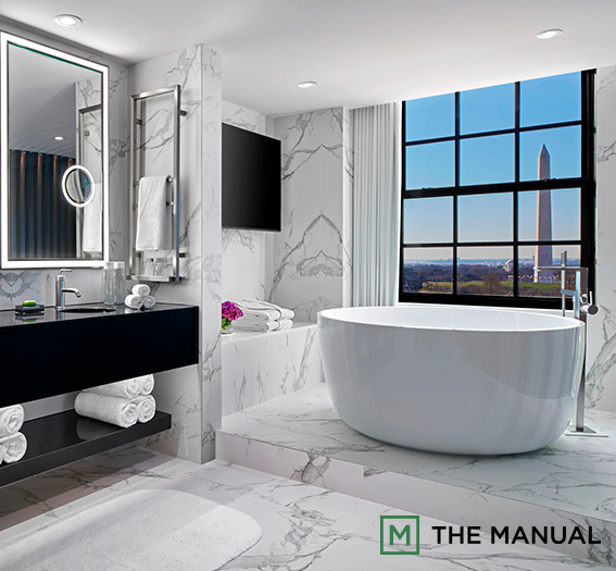a bathroom with a large tub and a large mirror