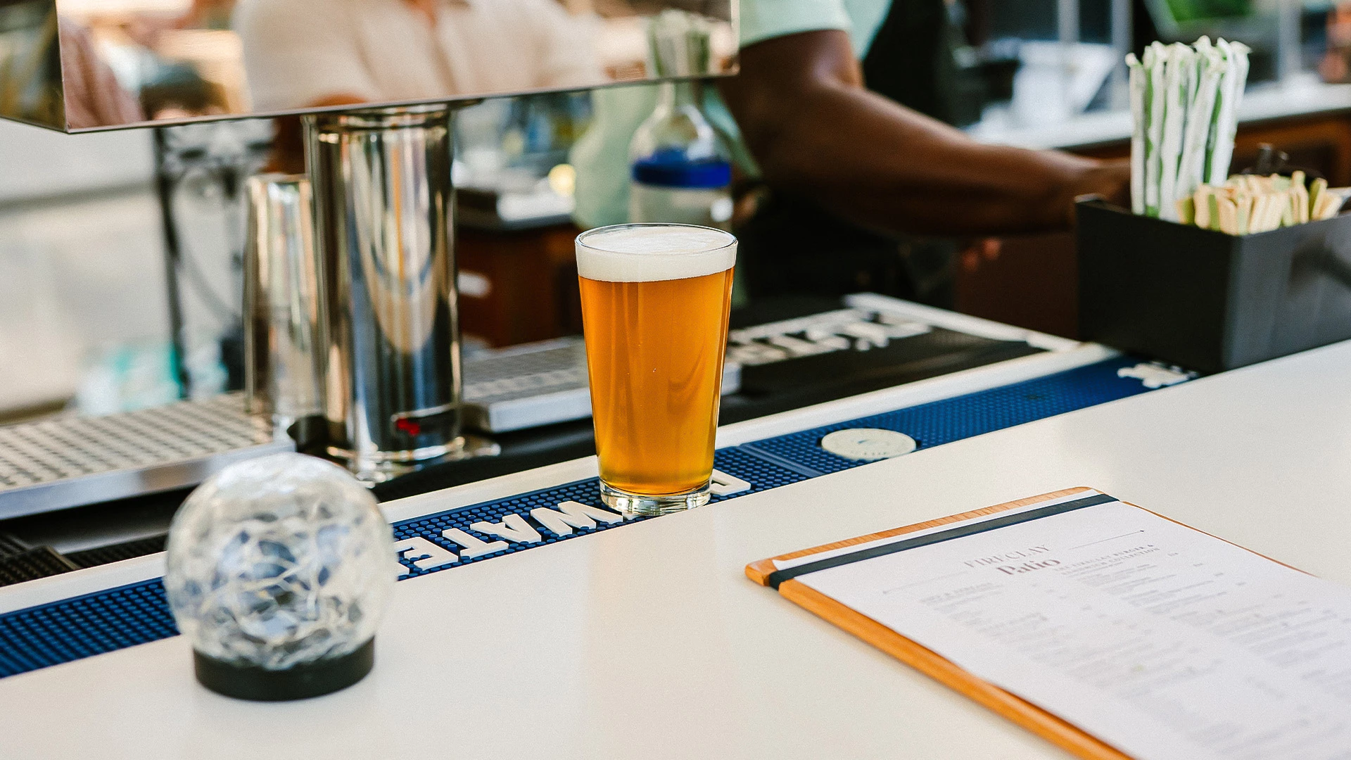 a glass of beer on a counter