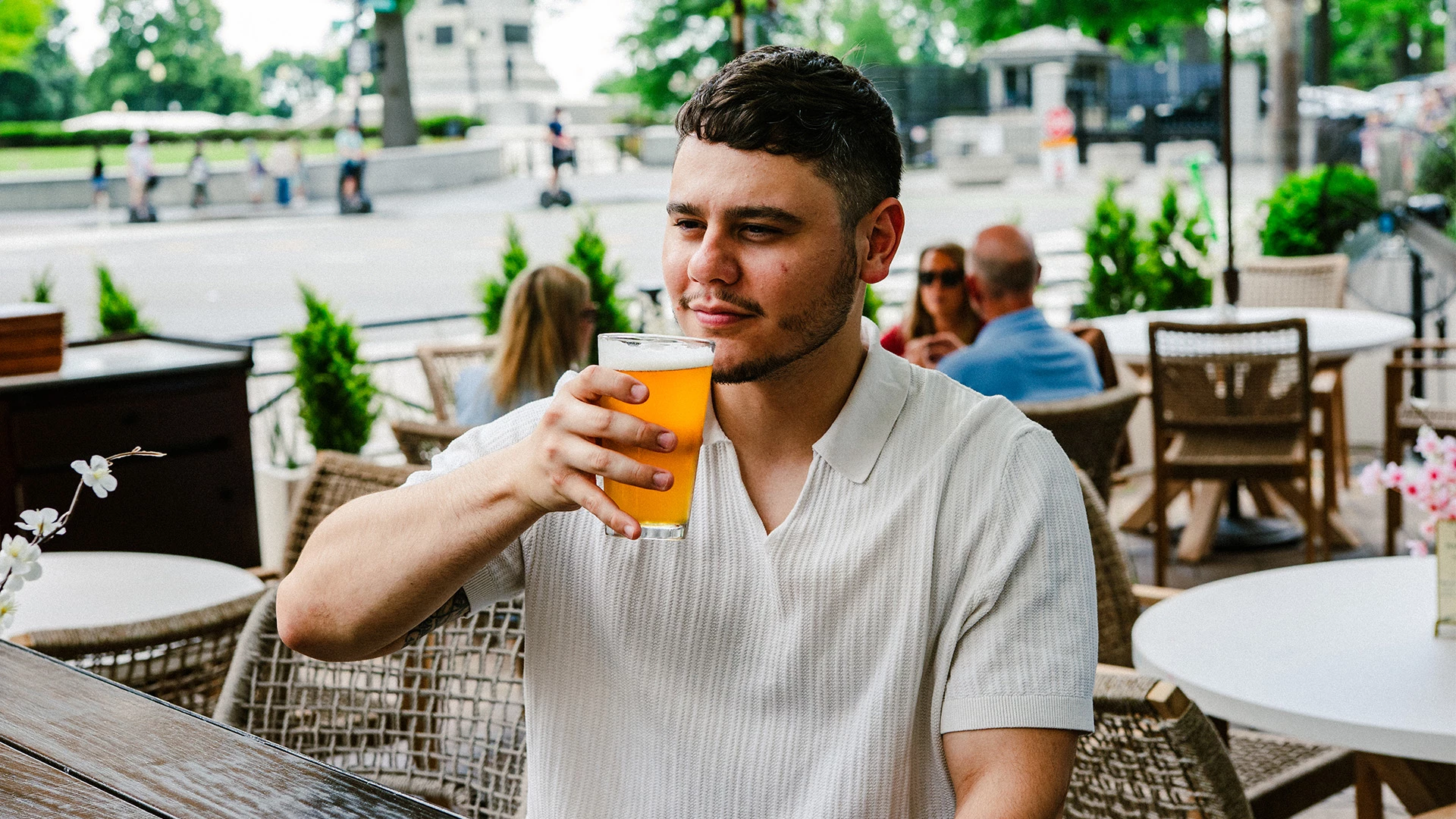a man holding a glass of beer