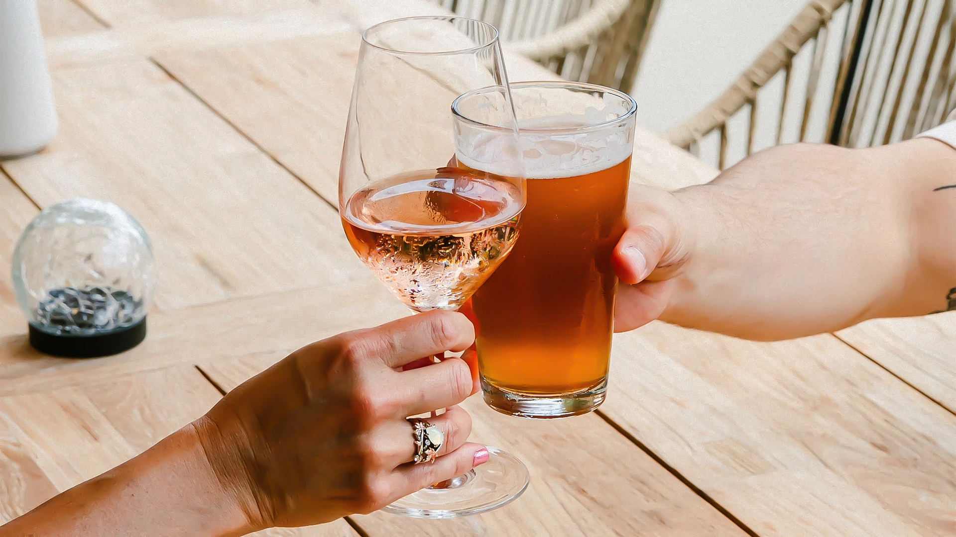 a couple of hands holding glasses of wine
