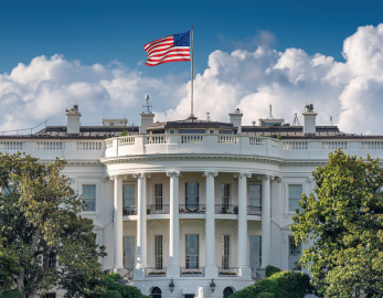 a white building with a flag on top
