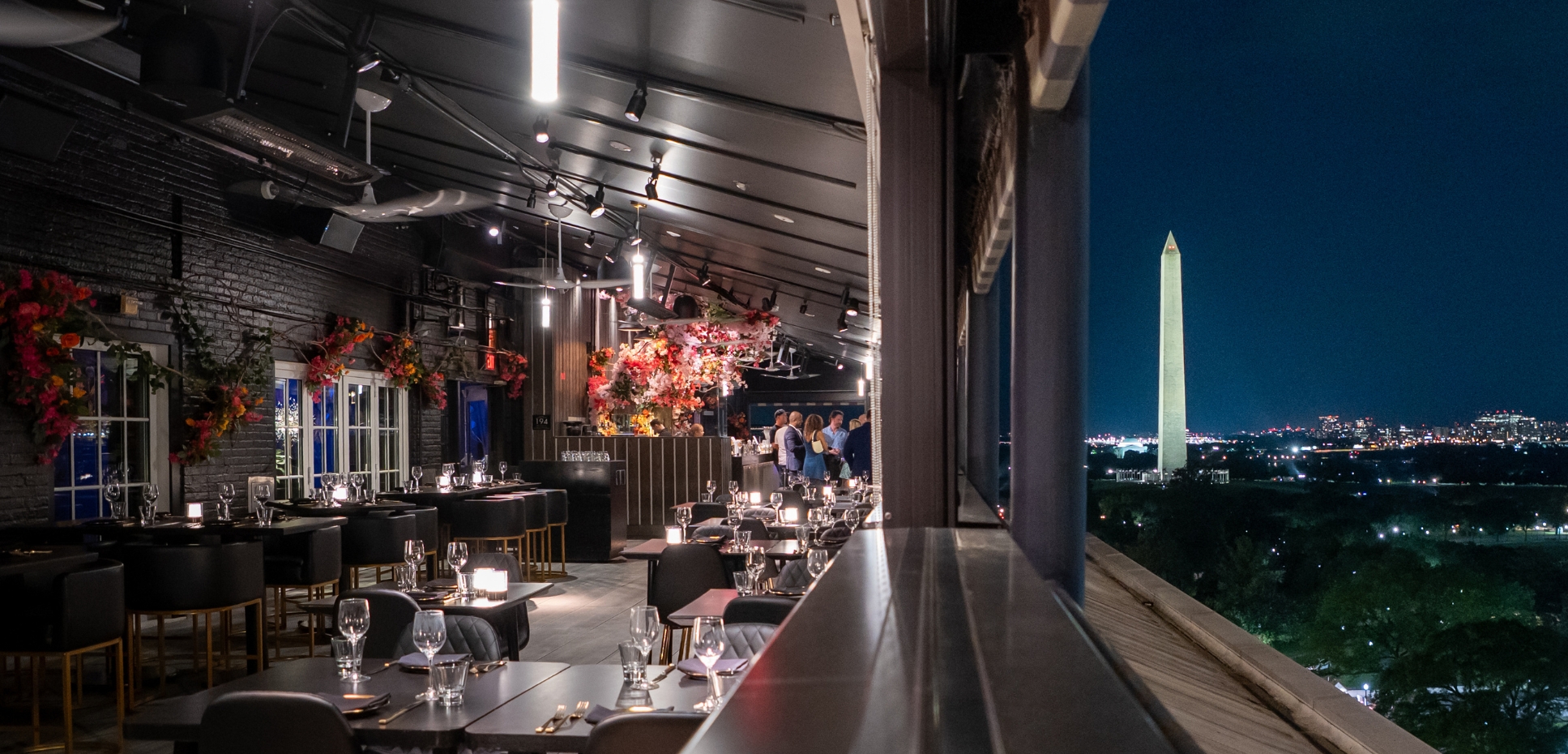 view of rooftop restaurant overlooking the washington monument at night