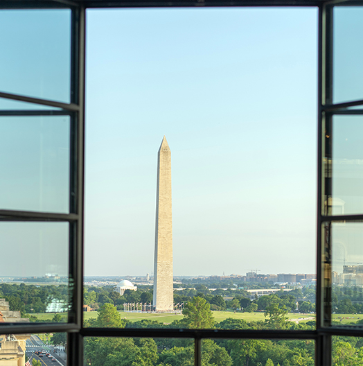 a tall monument seen through a window