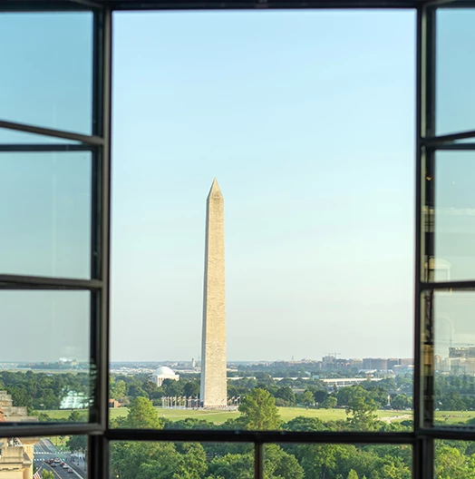 a tall monument seen through a window