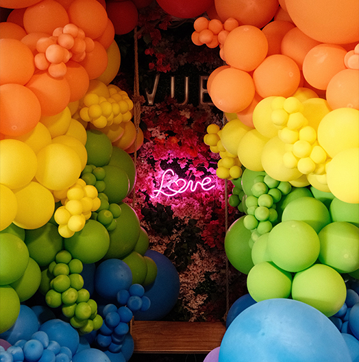 a group of balloons in a room