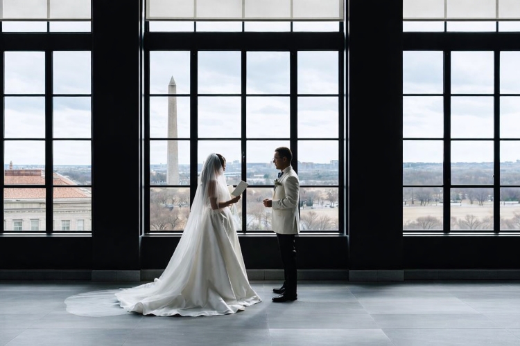 Romantic couple silhouette kissing in front of a window with Washington Monument view at Hotel Washington, showcasing luxury wedding venues in Washington DC