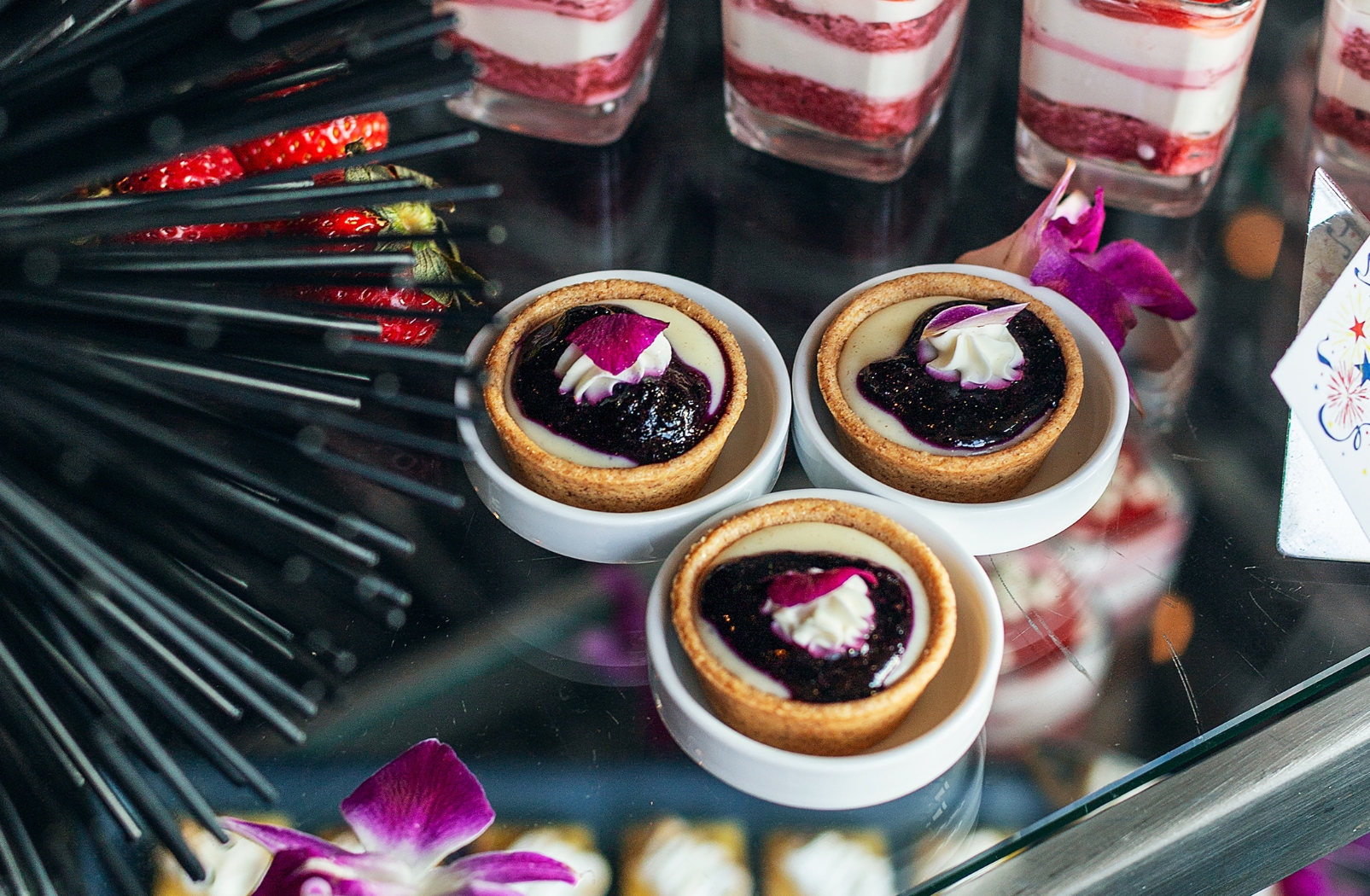 a group of desserts on a glass table