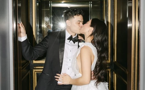a man and woman kissing in an elevator