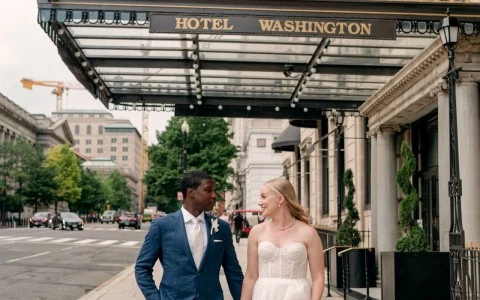 a man and woman in wedding attire walking on a sidewalk