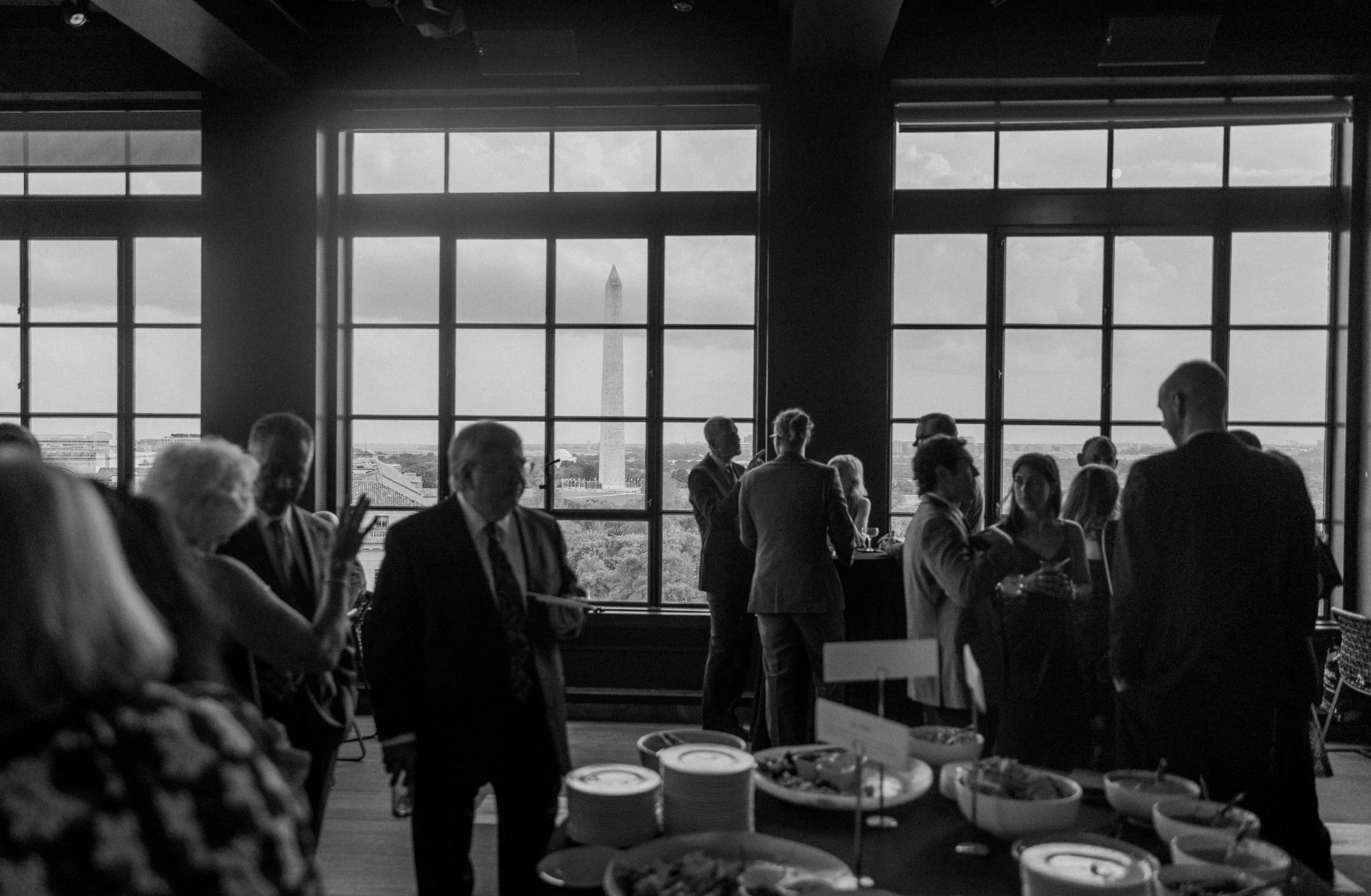a group of people in a room with a large window