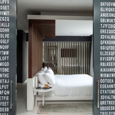 a bedroom with a bed and a table