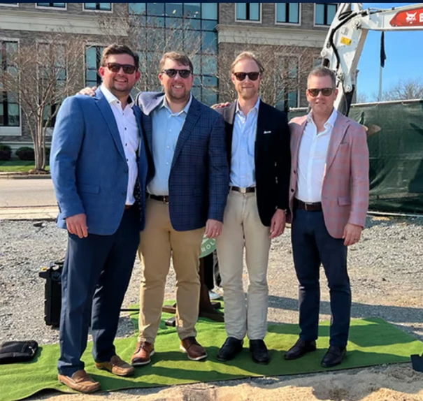 a group of men standing together outside