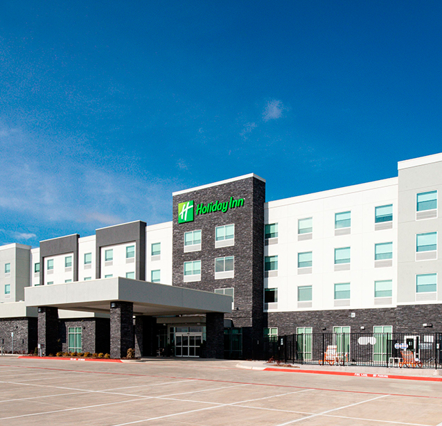 a building with a parking lot and a gate