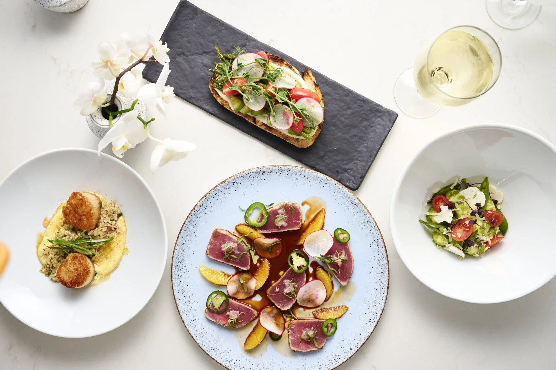 a table with plates of food and wine