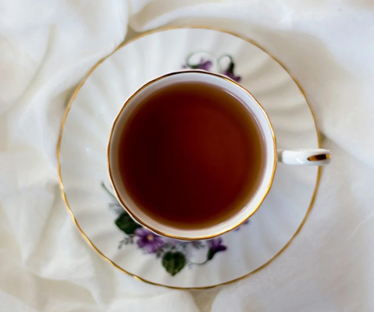 a cup of tea on a white cloth