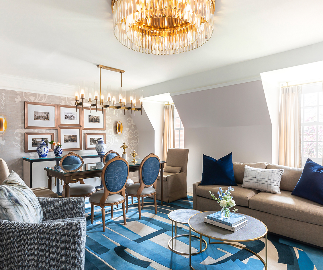 a living room with a chandelier and couches