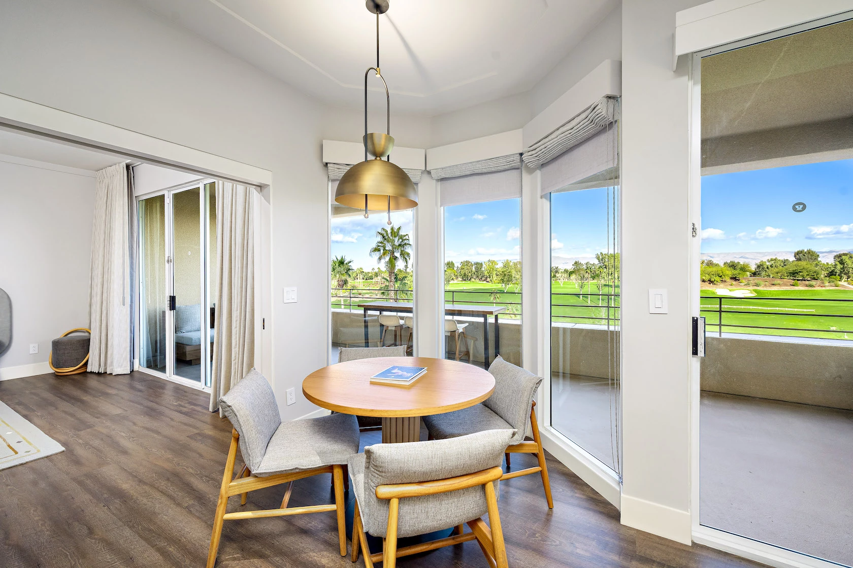 a room with a table chairs and a large window