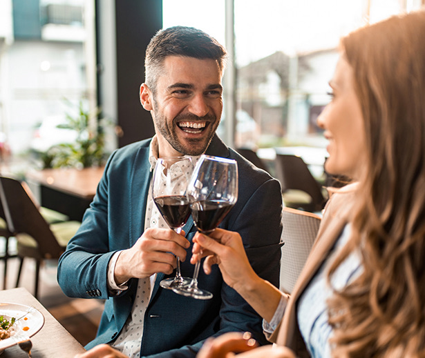 a man and a woman holding wine glasses