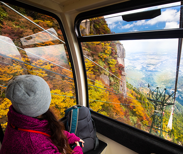 a person and a child looking out a window at a canyon