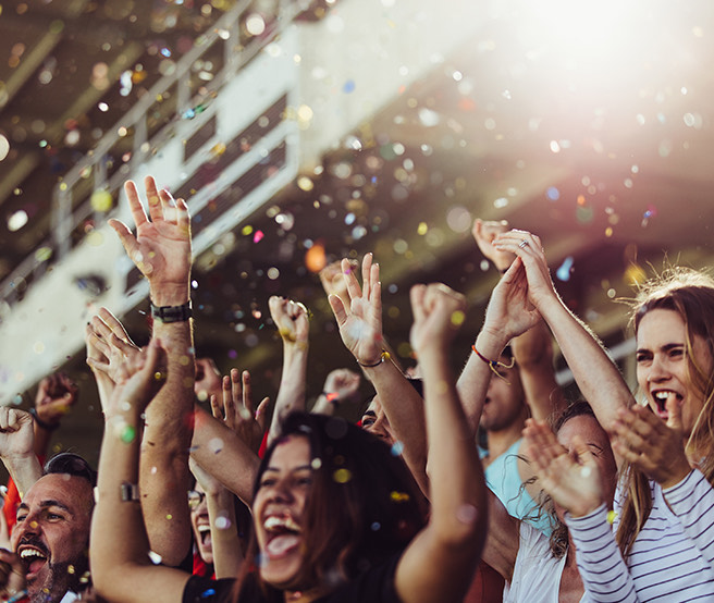 a group of people with their hands up in the air