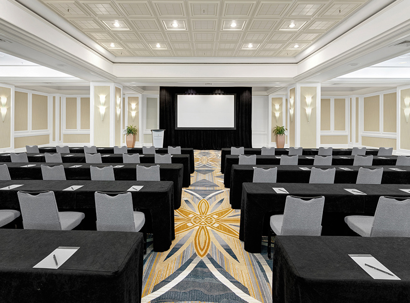 Sevilla Classrom Meeting Venue with five long tables in order with five chairs each table, all facing forward towards the presenter board 