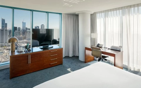 large room with a view of the city at dusk