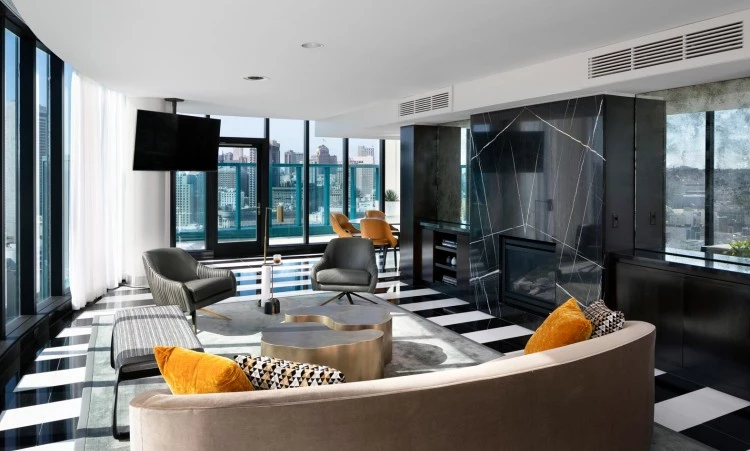 lounge area with chairs, tv, and a view of the city
