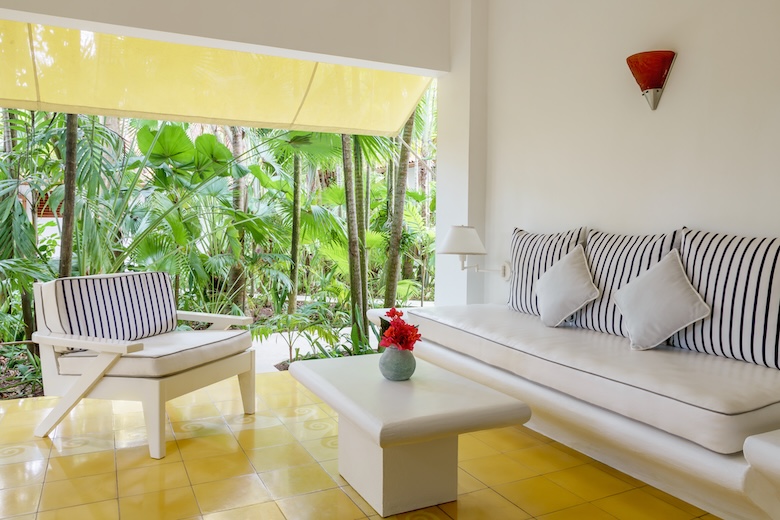 a room with a white couch and a white coffee table