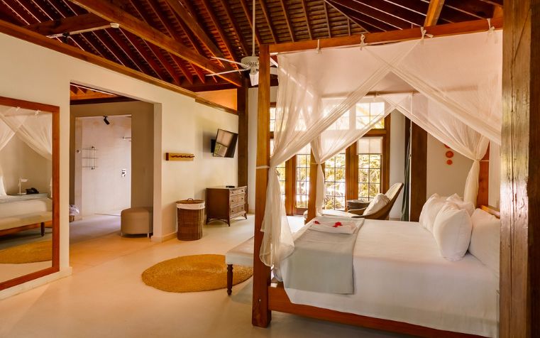 a bedroom with a canopy bed and a television