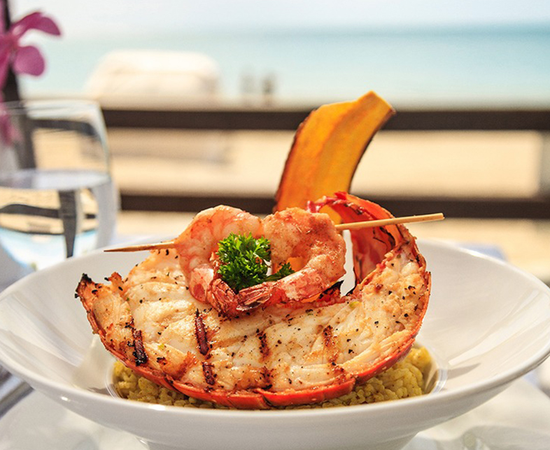 a plate of food with a skewer on top