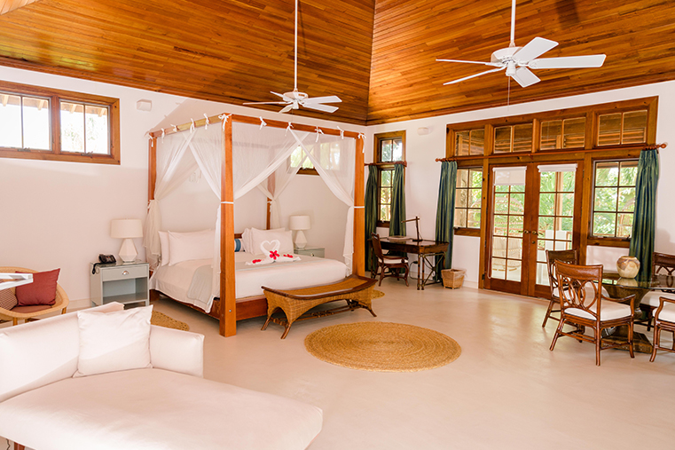 a room with a bed and a table and chairs