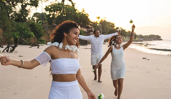 a group of people walking on a beach