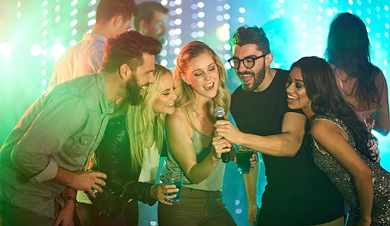 a group of people singing into a microphone