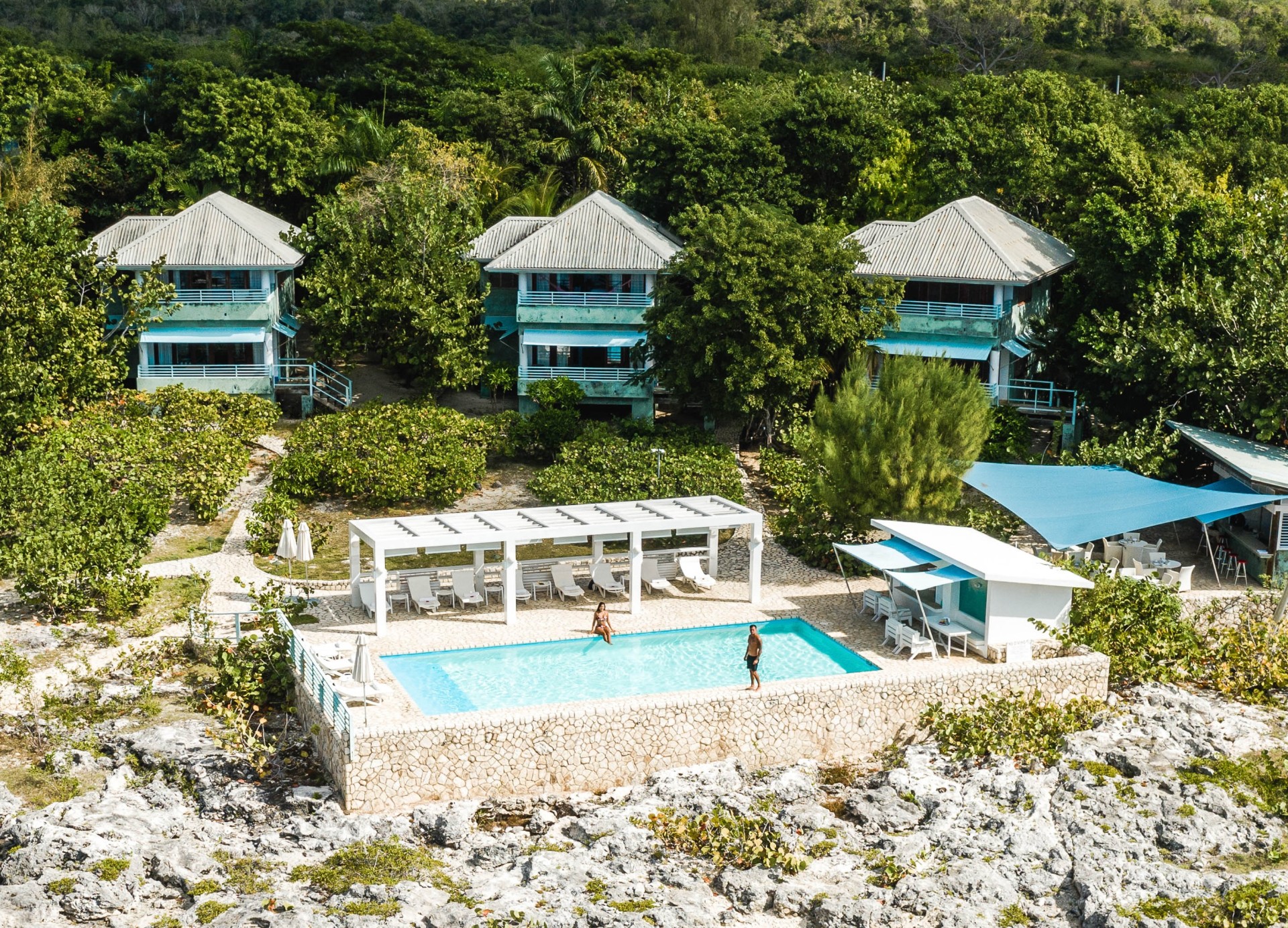 a person standing in a pool surrounded by buildings