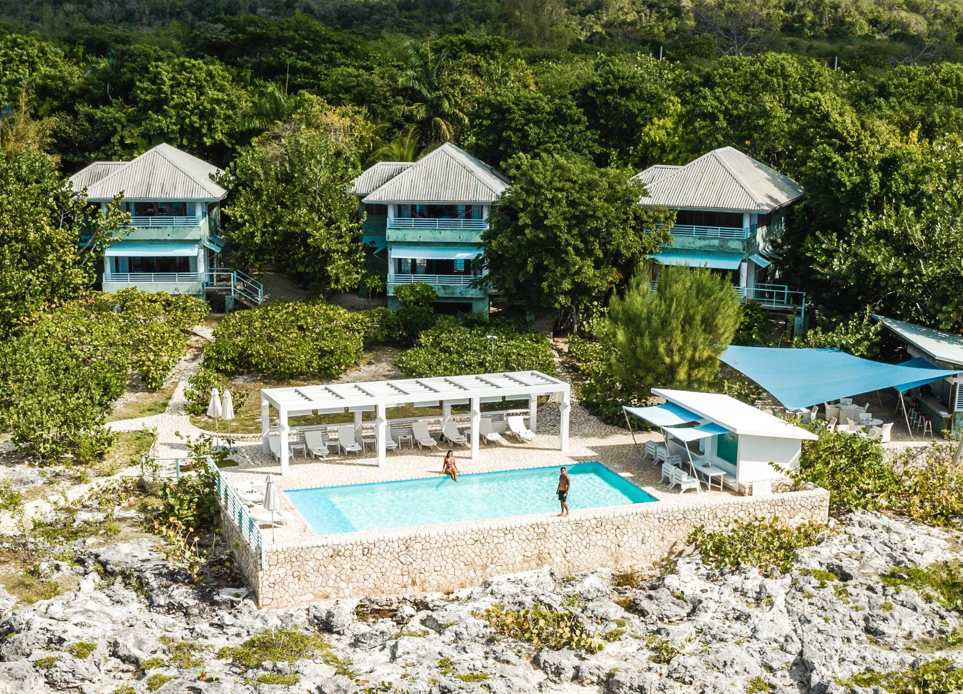 a person standing in a pool surrounded by buildings