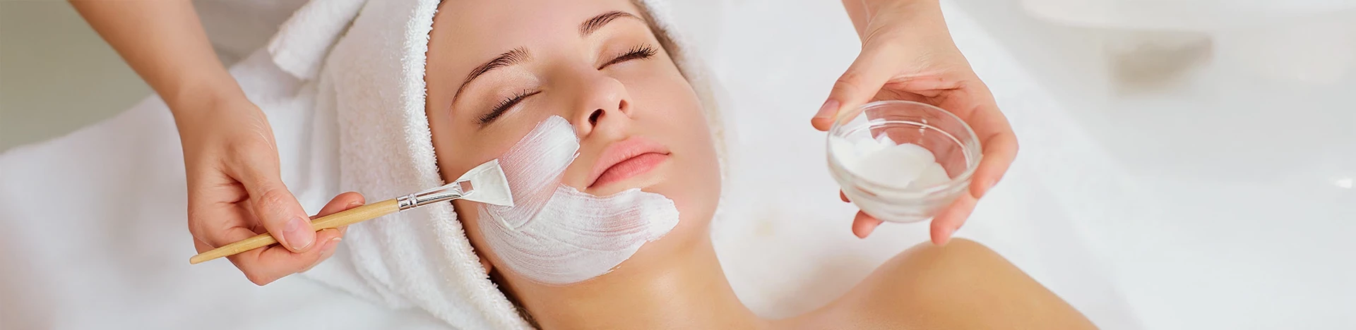 a woman with white cream on her face