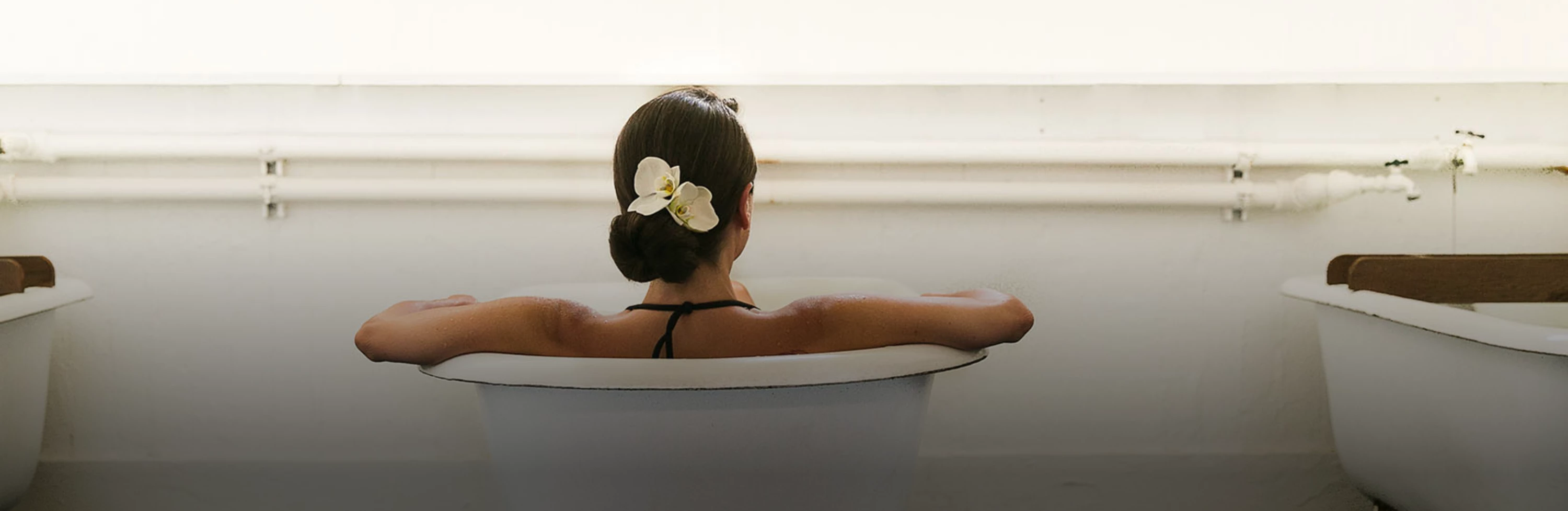 a woman sitting in a bathtub