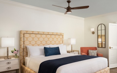 a bed with a fan in a room
