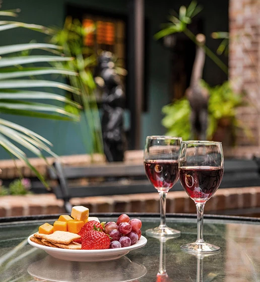 table with glasses of wine and cheese