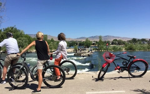 a group of people on bicycles by a body of water